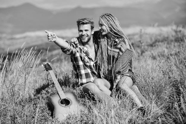 Couple happy cuddling nature background Romantic hike Family hike Boyfriend and girlfriend with guitar in mountains Enjoying each other Summer hike Breathtaking feelings Hiking romance