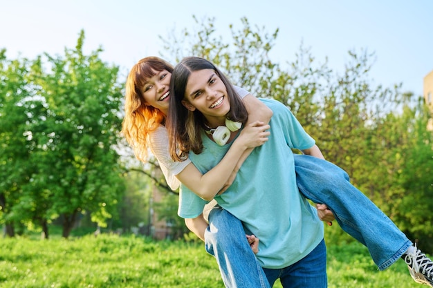 Couple of happy having fun teenagers together outdoor