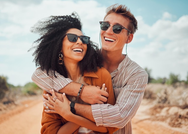 Couple happy and smile hug in nature on a travel adventure and road trip outdoor Happiness of traveling girlfriend and boyfriend together in the summer sun with quality holiday time in the dessert