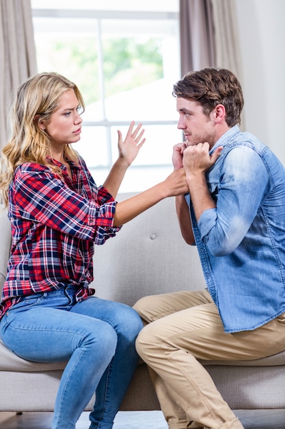 Couple having an argument on the sofa