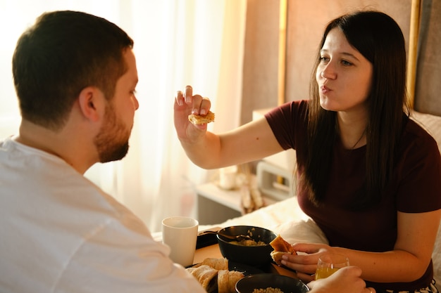 Couple having breakfast in bed