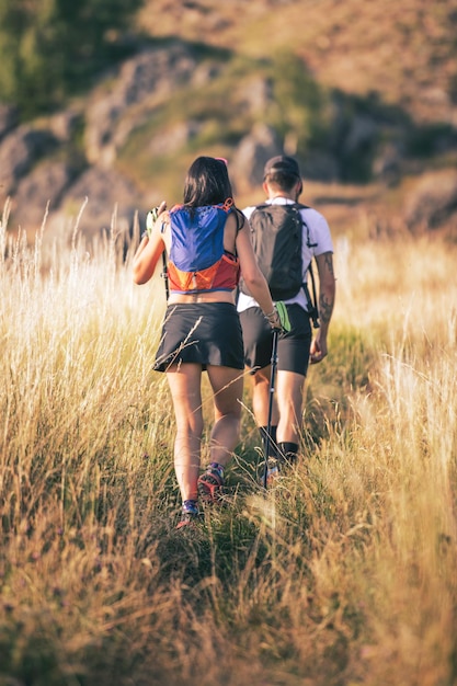 Couple of hikers on hillside trail