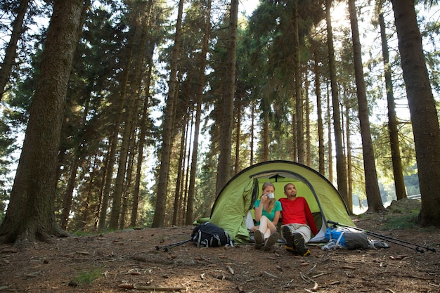 Couple of hikers rest in tent