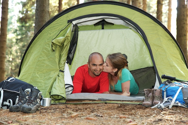 Couple of hikers rest in tent