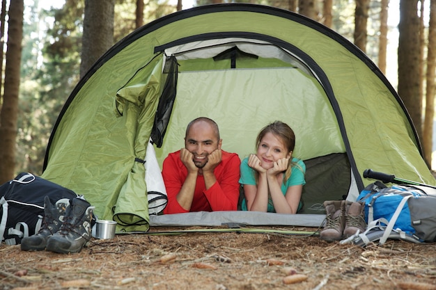 Couple of hikers rest in tent