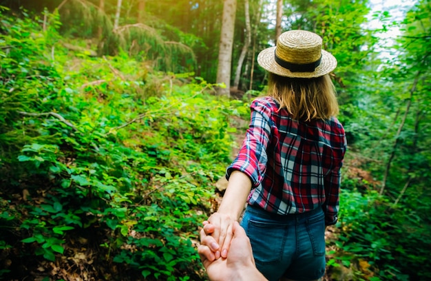 Couple hiking in the forest holding hands