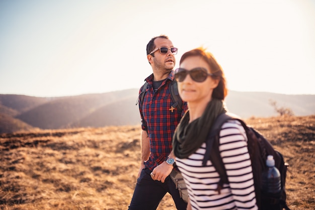 Couple hiking together on a mountain