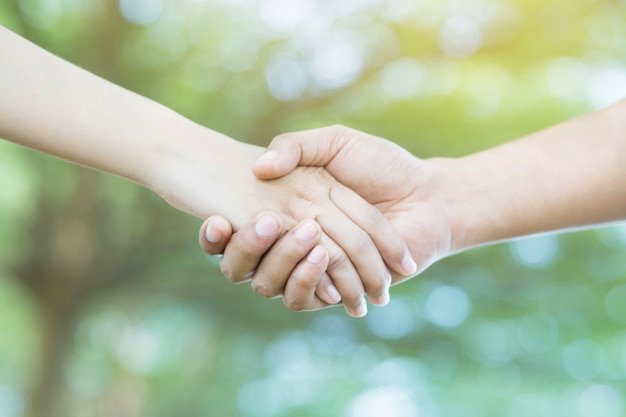 Couple holding hands on the park