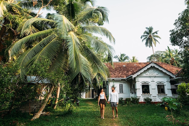 The couple in the home garden. Man and woman rent a house. A couple in love travels. Man and woman in Asia. Loving couple. Newly married couple. Wedding travel