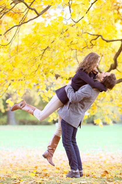 Couple hugging in autumn park