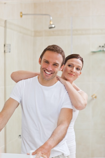 Couple hugging in the bathroom