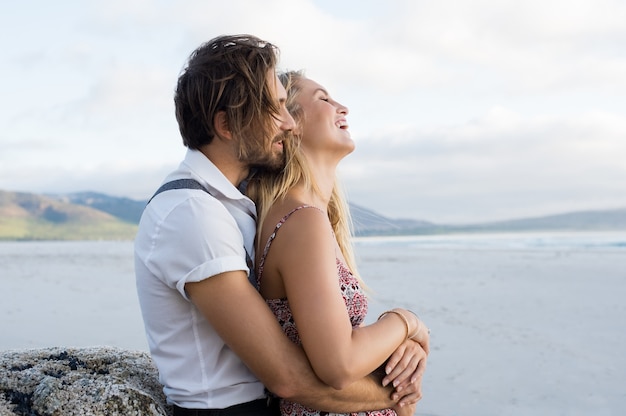 Couple hugging by the sea