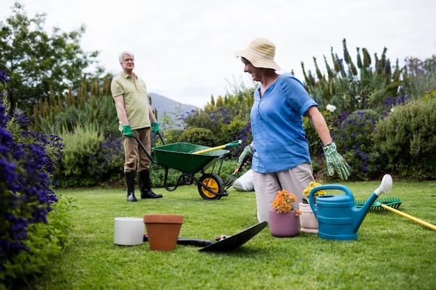 Couple interacting with each other while planting flower