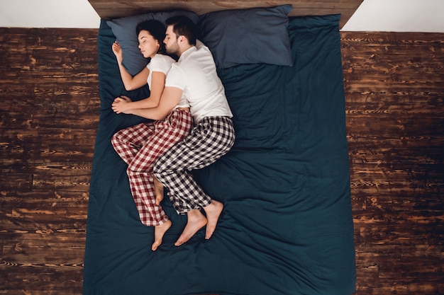 Couple is Lying and Sleeping on Bed