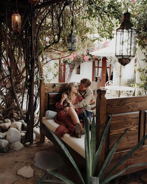 Photo a couple is sitting on a bench in a garden