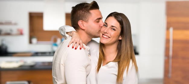 Couple kissing in a house