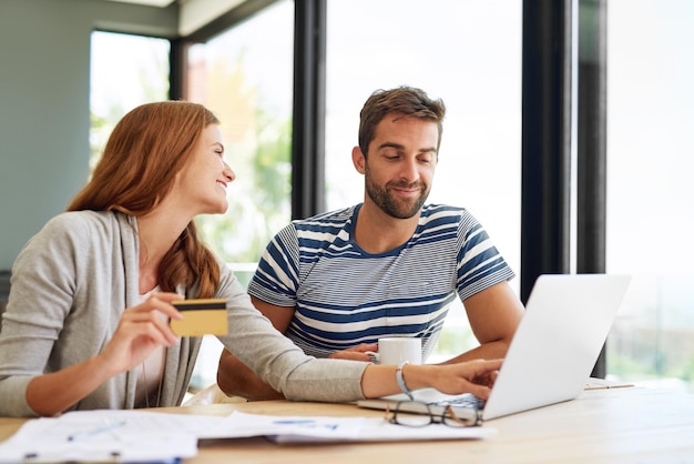 Photo couple laptop and credit card at table in morning for online shopping with purchase in house on weekend finance budget and internet banking with bills or monthly payments for taxes in apartment