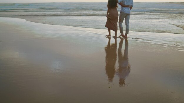 Couple legs crossing ocean at summer closeup embracing lovers rest foggy coast