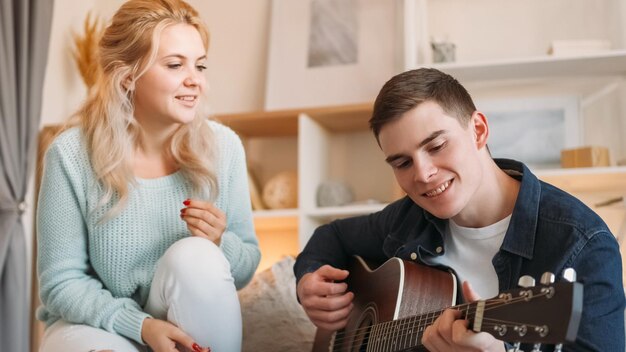 Couple leisure music lifestyle home weekend happy romantic man playing guitar for enjoying song