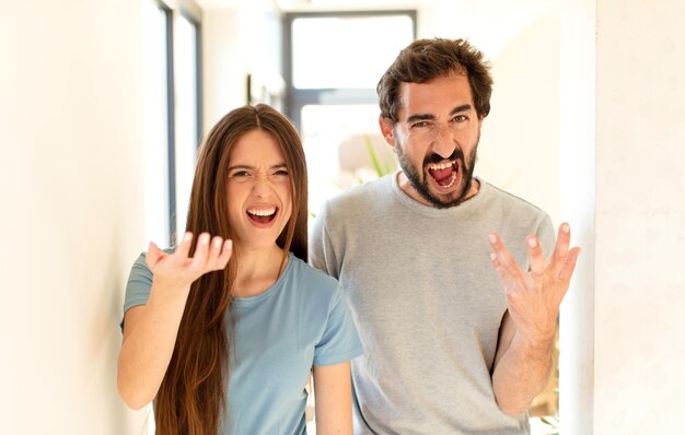 couple  looking angry, annoyed and frustrated screaming wtf or whatâs wrong with you