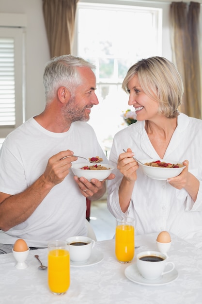 Couple looking at each other and having breakfast