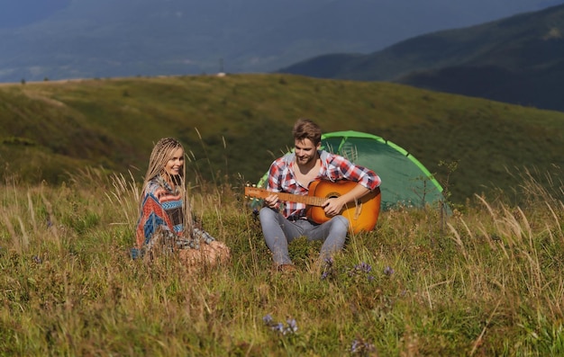 Couple in love camping romantic music and happy couple relationships romance couple with guitar