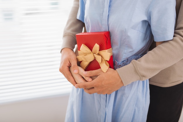 Couple in love. Couple hugging with wrapped present