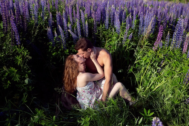 a couple in love embrace in a field of bright and beautiful flowers