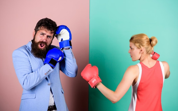 Couple in love fighting problems in relationship sport bearded man hipster fighting with woman family couple boxing gloves knockout punching who is right win the fight Strength and power