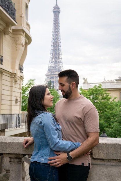 Couple in love gazing into each other39s eyes with the eiffel tower in the background