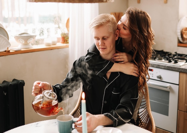 Photo a couple in love have breakfast and drink tea in a decorated eco-style kitchen in a country house