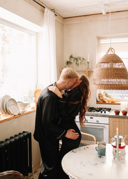 Photo a couple in love have breakfast and drink tea in a decorated eco-style kitchen in a country house