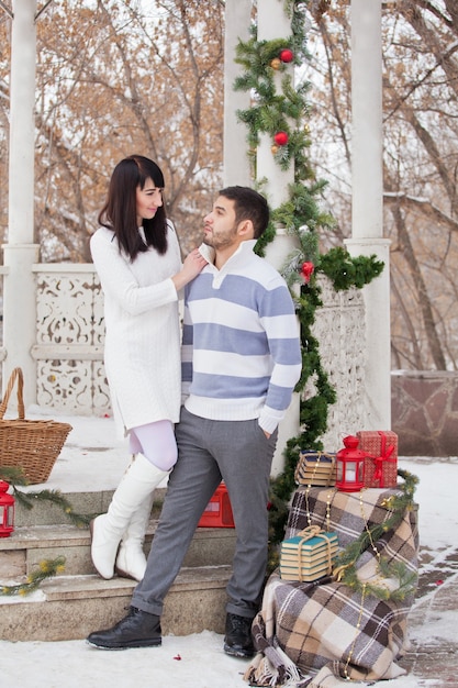 Couple in love hugging in christmas decorated gazebo