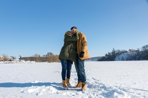 Couple in love kissing in winter sunny day