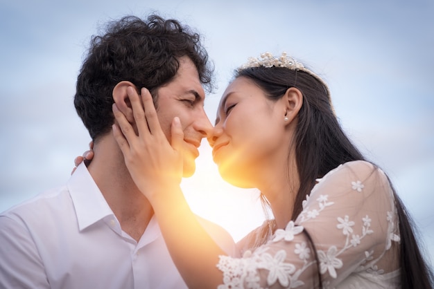 Couple in love kissing with sunlight