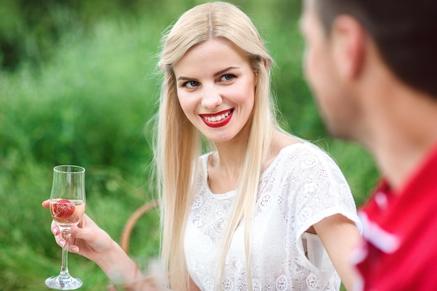 Couple in love at a picnic in a park with green grass