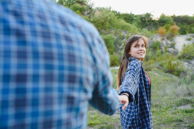 Couple in love rest on green hill in country side