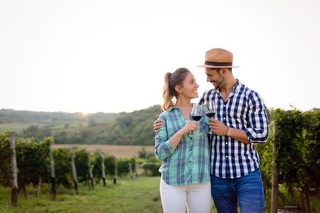 Couple in love working at winemaker vineyard and tasting wines