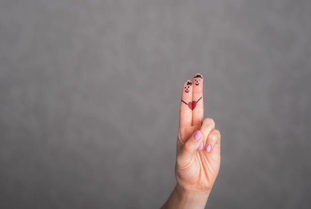 A couple of lovers are painted on fingers  Funny fingerspeople on a date Caricatures of people on fingers Body art on the fingers