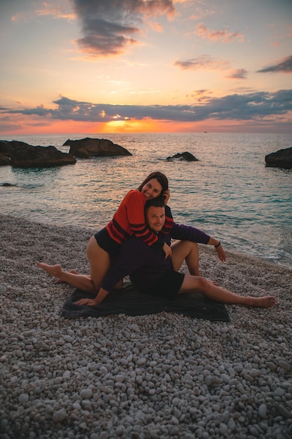 Couple lovers at the beach enjoying time together and sunset above the sea Greece vacation Lefkada island