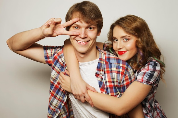 Couple in loveYoung woman and man wearing casual wear over grey background