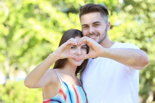 Couple making heart shape with hands