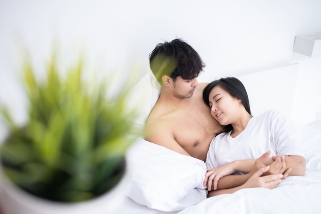 Couple man and woman slpeeing on bed