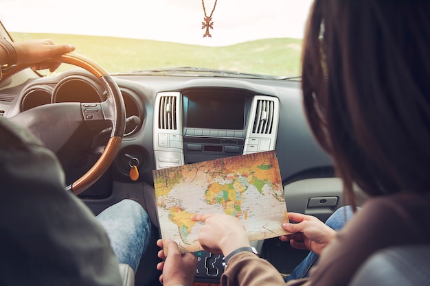 Couple and map in car