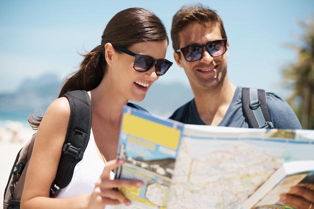 Couple map and search on travel by ocean mountains or idea to check direction for help on vacation Woman man and chart for location landmark or reading with thinking on holiday at beach in Italy