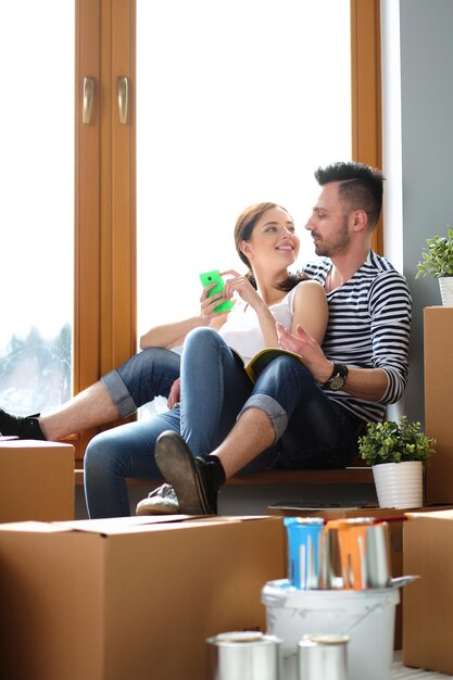 Couple moving in house sitting on the floor Couple