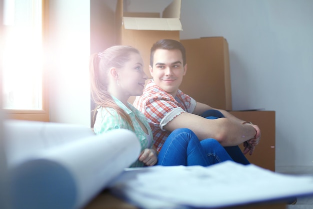 Couple moving in house sitting on the floor Couple