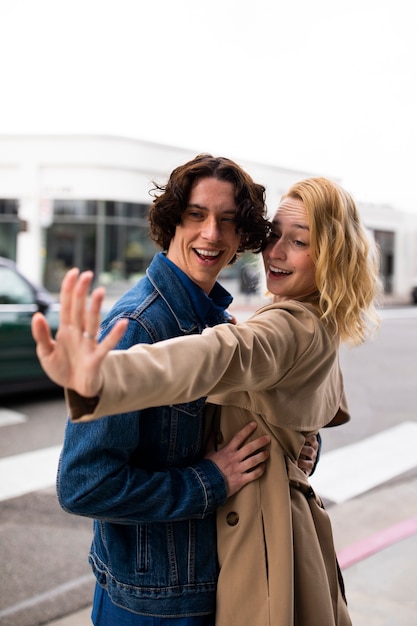 Couple outdoors in the city after proposal with engagement ring