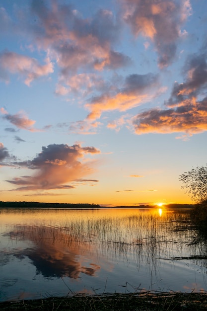 Couple on the pier at a large lake during sunset