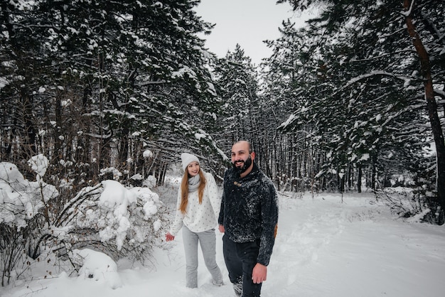 Couple playing with snow in the forest